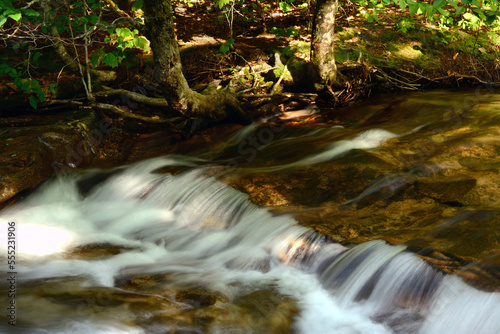 Water cascading over rock at Diana's Baths in the White Mountains of New Hampshire.; Bartlett, New Hampshire, USA. photo