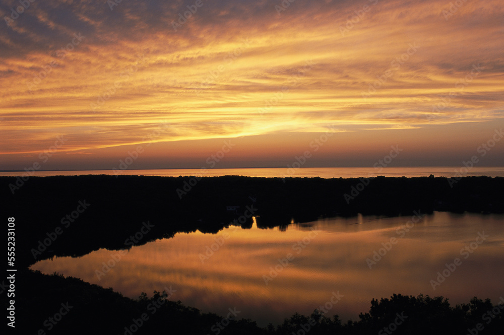 Sunset view of ocean and Scargo Lake looking north from Scargo Tower.; Dennis, Cape Cod, Massachusetts. Sunset view of ocean and Scargo Lake looking north from Scargo Tower.; Dennis, Cape Cod, Massachusetts.