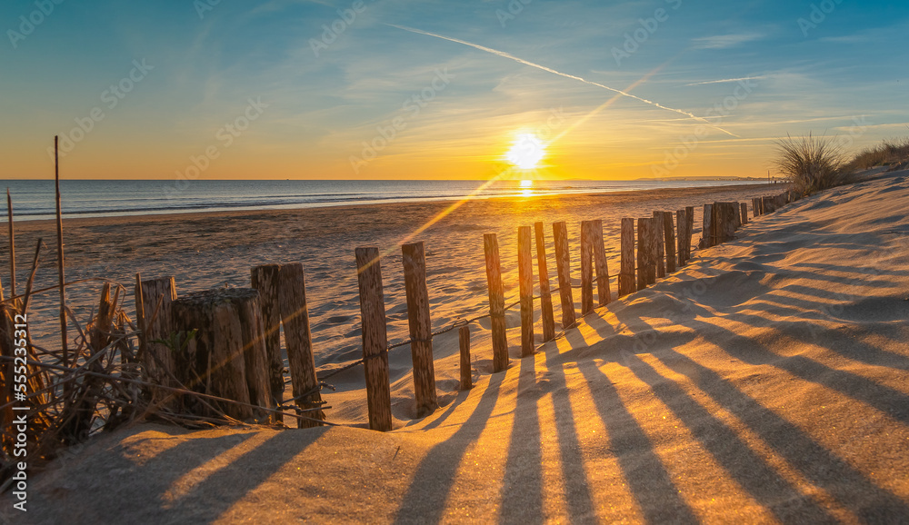 Coucher de soleil sur la plage du Grand Travers à La Grande Motte, France.  Très belle plage avec les dunes de sable. Stock Photo | Adobe Stock