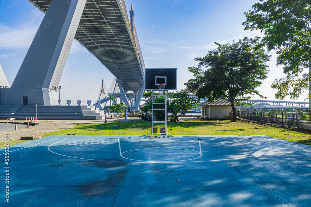 basket ball court under a bridge