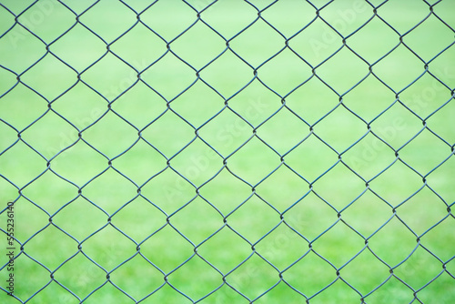 Wire fence with green background
