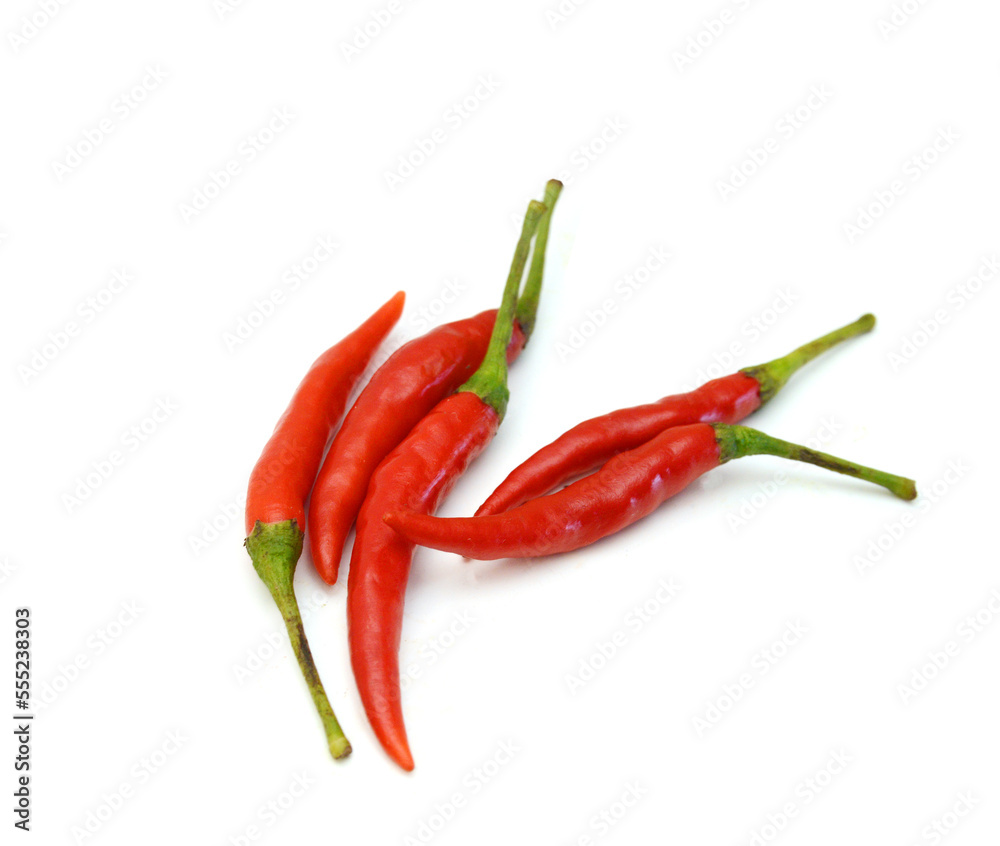 Stack red chili peppers and basil herb leaves on the white Stack red chili peppers and basil herb leaves on the white