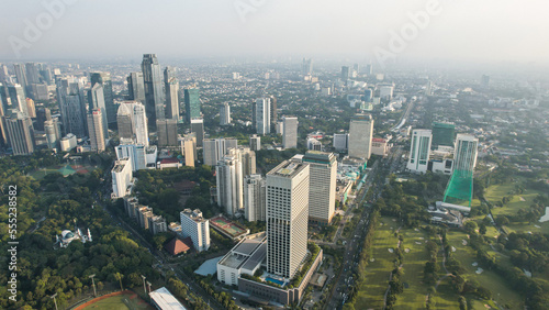 Aerial view of office buildings in Jakarta central business district and noise cloud when sunset. 