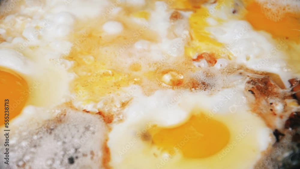 Scrambled eggs with bacon cooked in a frying pan Scrambled eggs with bacon cooked in a frying pan