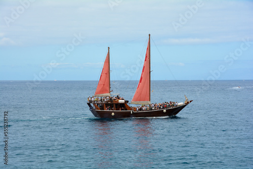 A sailboat with tourists on board at sea