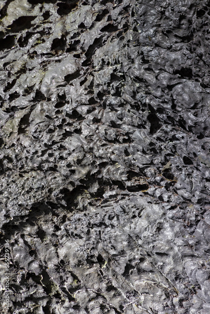 Exploring a volcanic cave in the Volcanic Caves Park at the foot of Villarrica volcano in Pucon, Chile 