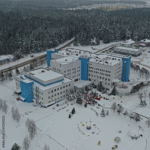 Borovlyany, Belarus - 18.12.2022: Charity event: Santa Clauses-alpinists descend from the roof to wish New Year and Merry Christmas to children in the cancer center and give them gifts