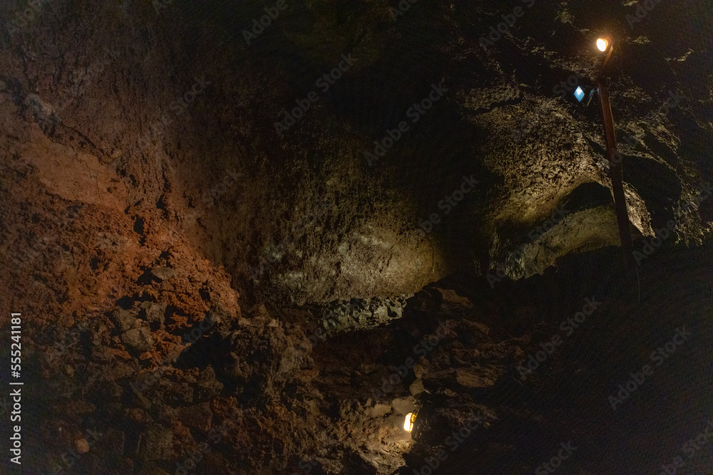 Exploring a volcanic cave in the Volcanic Caves Park at the foot of Villarrica volcano in Pucon, Chile Exploring a volcanic cave in the Volcanic Caves Park at the foot of Villarrica volcano in Pucon, Chile