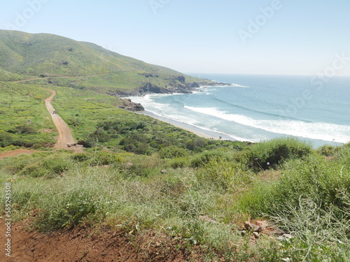 Baja, Mexico coastline with dirt road and rolling green hill sides photo
