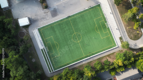 Photography Aerial overhead shot of a soccer field at a school or park, with green grass