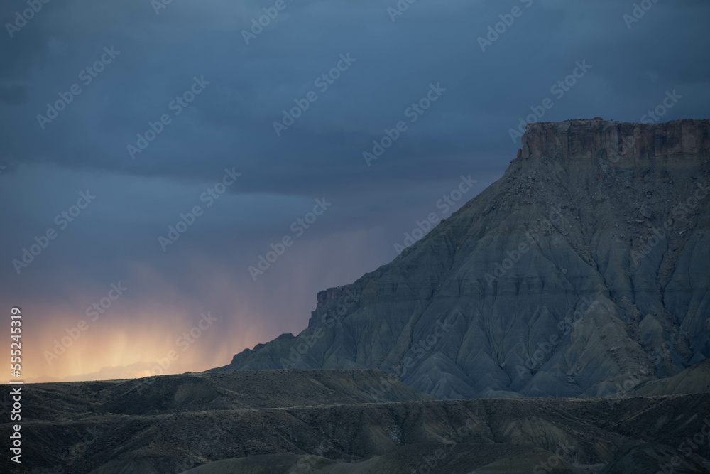 Stormy sunset skies surrounding Factory Butte in Caineville, Utah