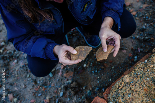 Photography Old clay shards in the hands of an archaeologist