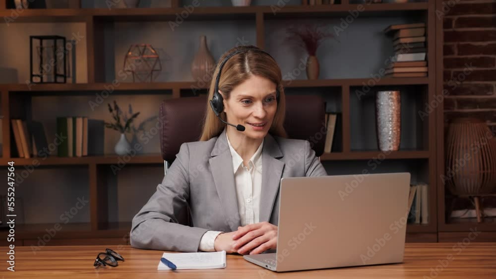 Smiling young confident business woman make conference call in office, smart female manager talk look at camera laptop communicating in online video chat, distance job interview concept, webcam view. Smiling young confident business woman make conference call in office, smart female manager talk look at camera laptop communicating in online video chat, distance job interview concept, webcam view.
