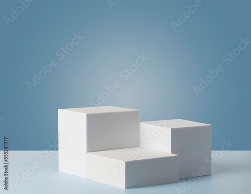 Square podiums are white. Abstract background. A stage for the demonstration of cosmetics. Podium for the award, consisting of three 3 square figures of different sizes on a blue background. Showcase