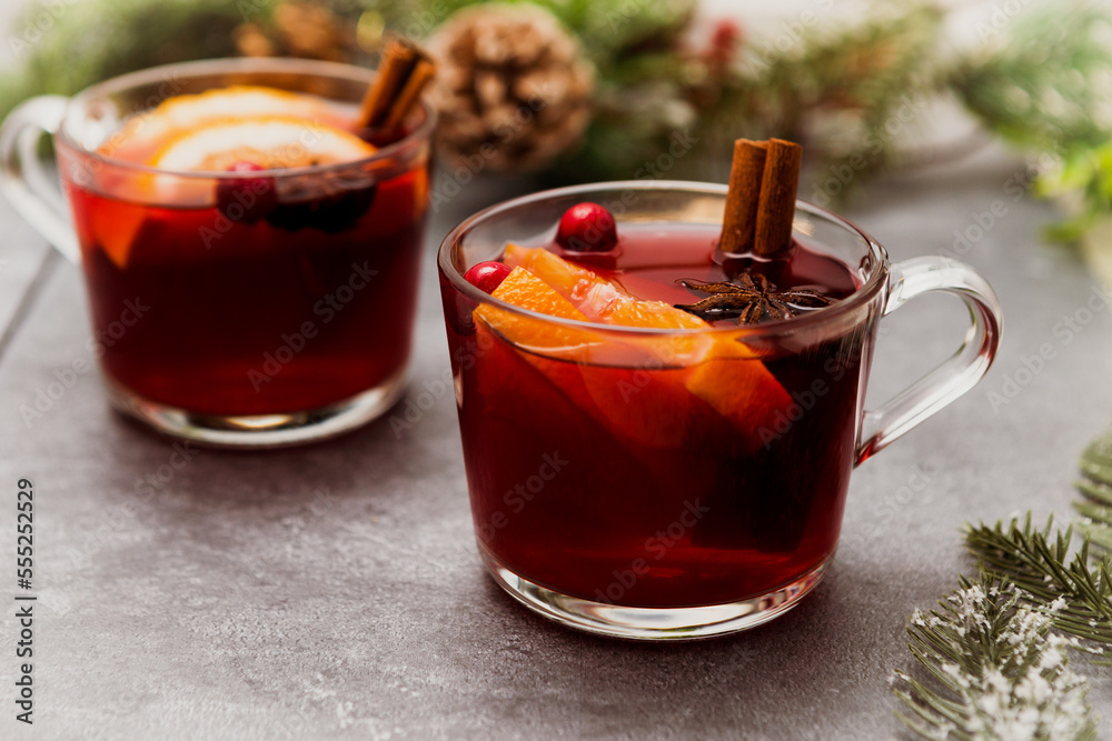 Two cups of christmas mulled wine or gluhwein with spices and orange slices on rustic table top view. Two cups of christmas mulled wine or gluhwein with spices and orange slices on rustic table top view.
