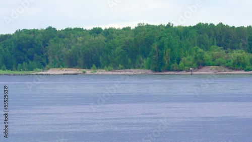 barge transporting gravel along a river