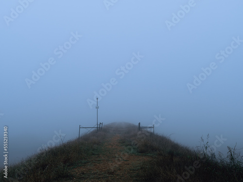 Foggy outdoor scene with hills and trails