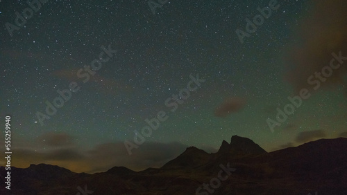 Night sky with stars and Big Dipper constellation over peaks of Pyrenees mountains with green air glow, Col du Pourtalet, Nouvelle-Aquitaine, France
