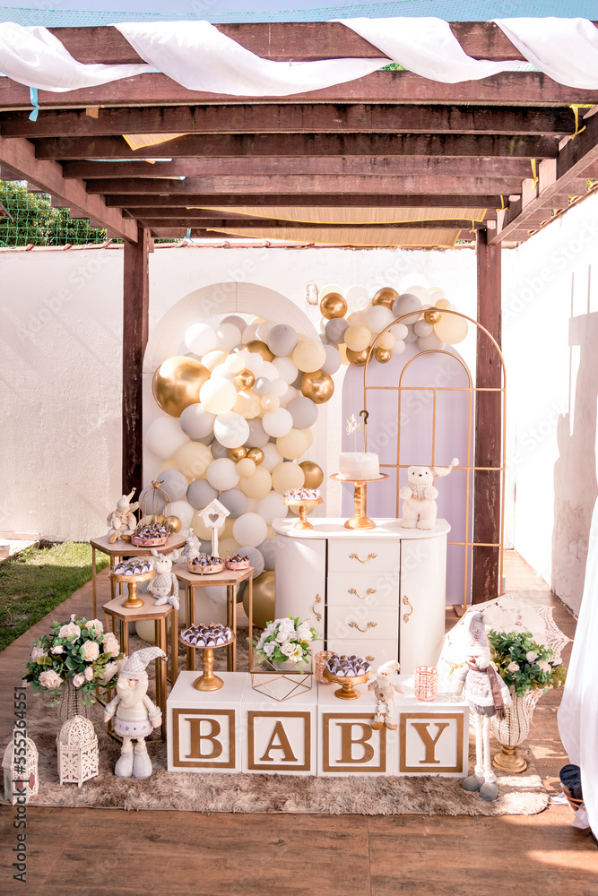 Fototapeta premium white and gold themed baby shower decor, teddy bears and santa claus