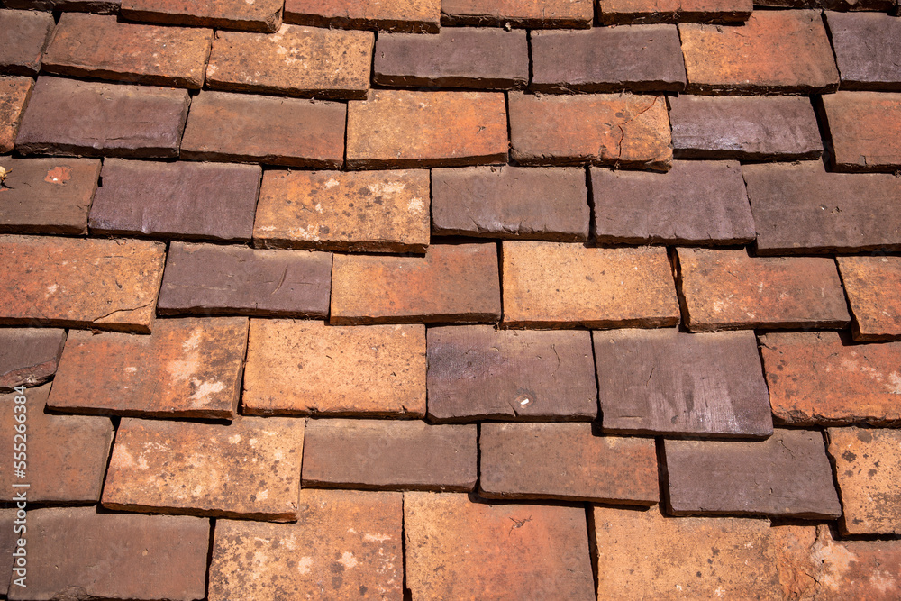 Medieval tiled roof made of handmade clay tiles as texture or background Medieval tiled roof made of handmade clay tiles as texture or background