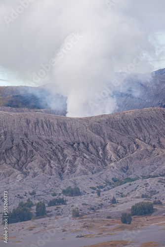 Mount Bromo with a puff of smoke from its caldera. Photographed with close up to see the natural details. The Bromo Tengger Semeru area is a popular tourist destination in East Java, Indonesia.