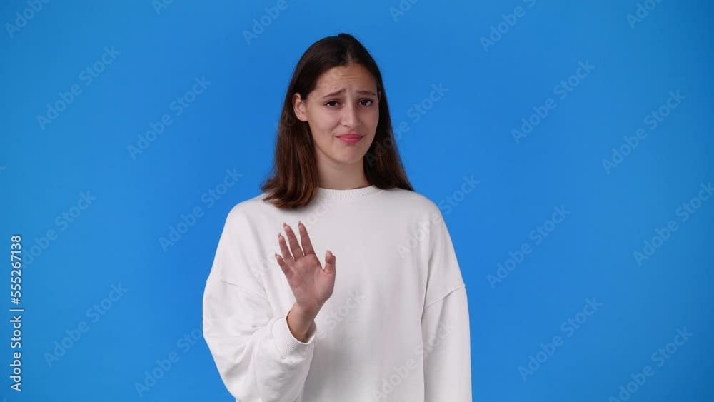 4k slow motion video of a girl gesturing no over blue background. 4k slow motion video of a girl gesturing no over blue background.
