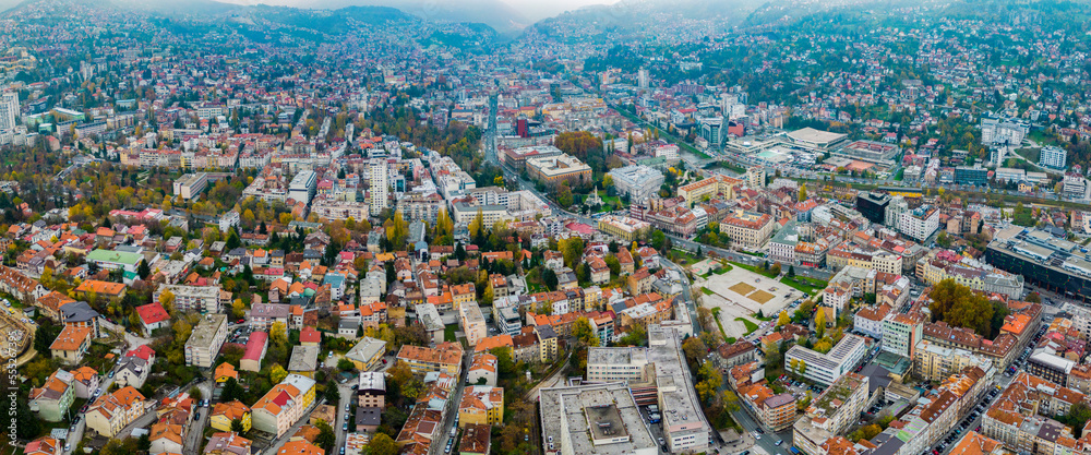 Aerial view around the capital city Sarajevo in Bosnia and Herzegovina on a cloudy and foggy day in autumn.	
