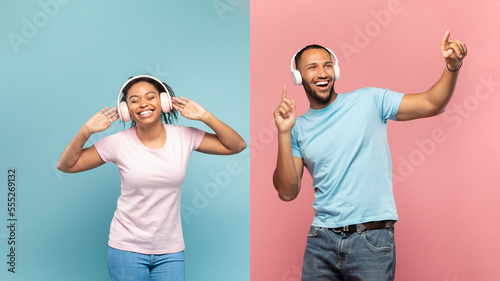 Favourite playlist. Excited carefree black couple enjoying music in wireless headphones over blue and pink background