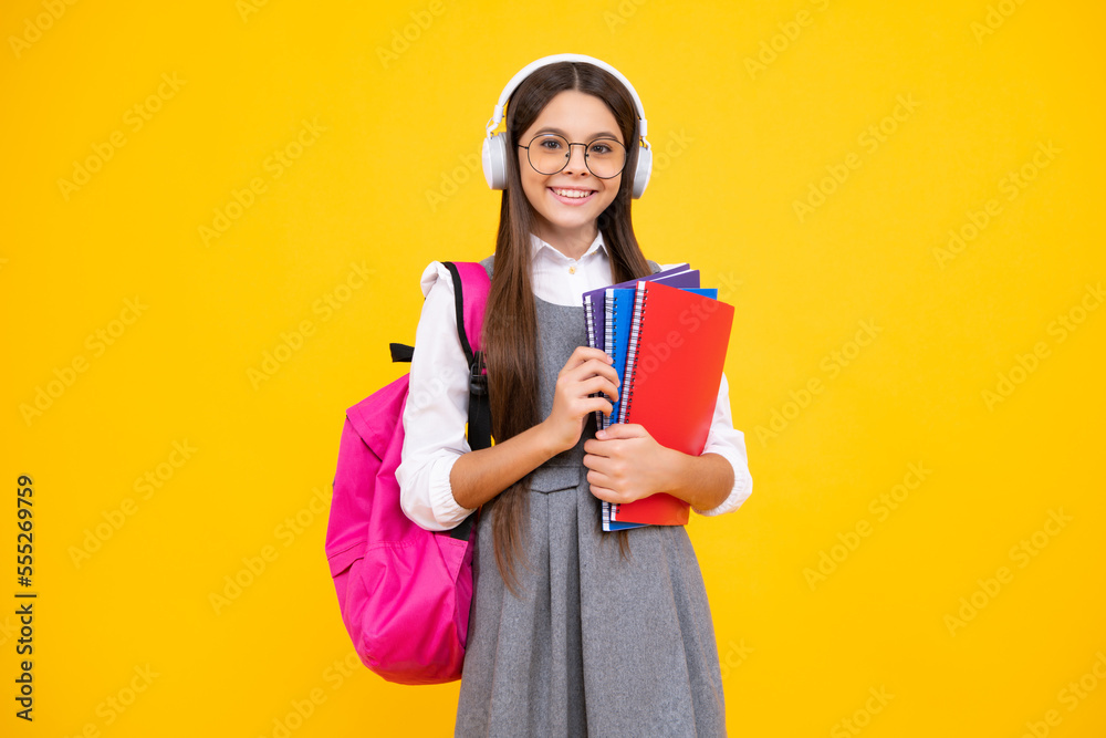 Back to school. Full length of teenager school girl with backpack hold aplle ready to learn. School children with school bag on isolated yellow studio background. Happy face, positive and smiling Back to school. Full length of teenager school girl with backpack hold aplle ready to learn. School children with school bag on isolated yellow studio background. Happy face, positive and smiling