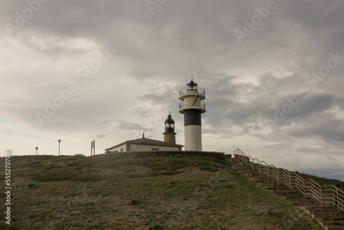 a view of two lighthouses with a cloudy sky