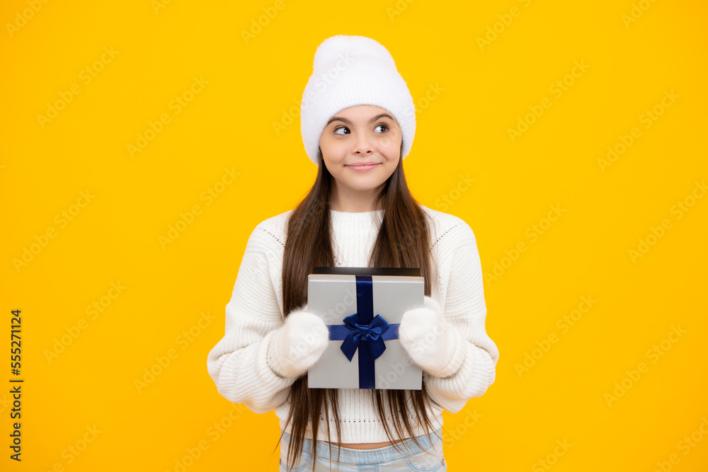 Teenager child with gift box. Present for winter holidays. Happy New Year or Christmas. Kid in sweater hold present box with gift ribbon bow. Teenager child with gift box. Present for winter holidays. Happy New Year or Christmas. Kid in sweater hold present box with gift ribbon bow.