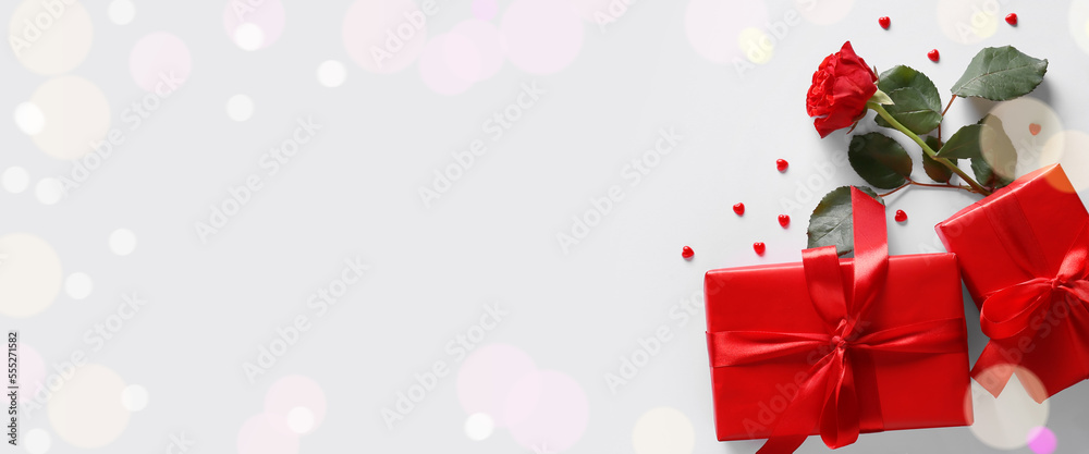 Presents for Valentine's Day, small hearts and beautiful rose on light background with space for text