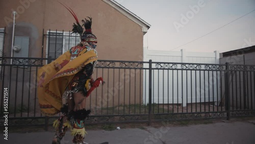 Mexica Aztec Dancer Skateboarding Alleyway  photo