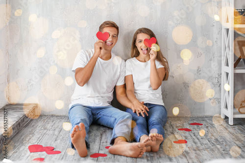 Funny young couple with red...