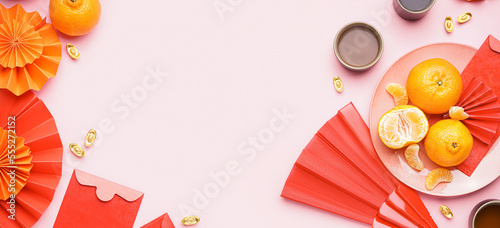 Red envelopes and Chinese symbols on pink background with space for text