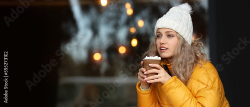 Beautiful young woman drink...