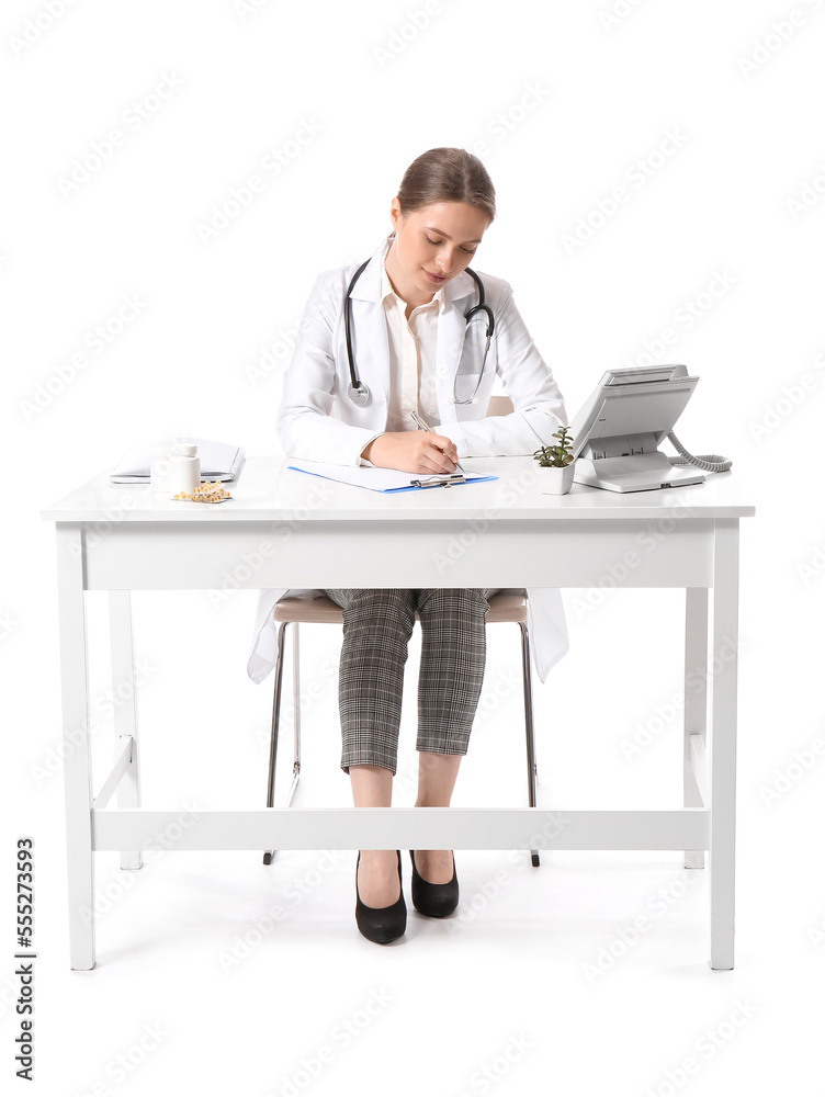 Female doctor writing in clipboard at table on white background Female doctor writing in clipboard at table on white background