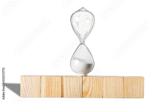 Hourglass on stack wooden cube