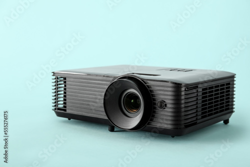 Black video projector on blue background