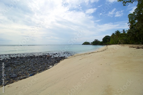 Tropical Beach  Rock  Wave and Blue Sea Water. This photo was taken on one of the tropical islands in Kotabaru  Indonesia.