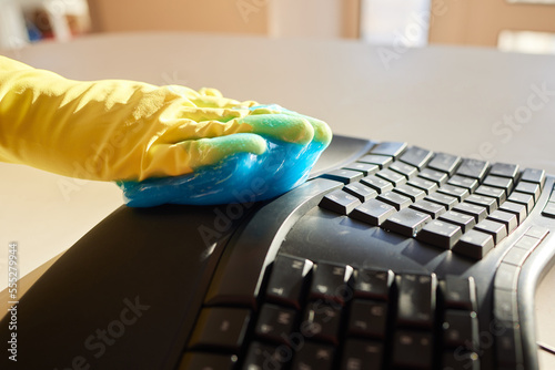 Blue soft gel cleaning dust on keyboard. Concept cleaning your computer's keyboard. Office cleaning. photo