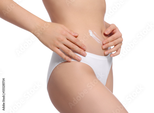 Young woman with body cream smear on belly against white background, closeup