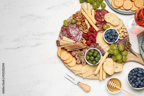 Принти на полотні Tasty parmesan cheese and other different appetizers on white marble table, flat lay