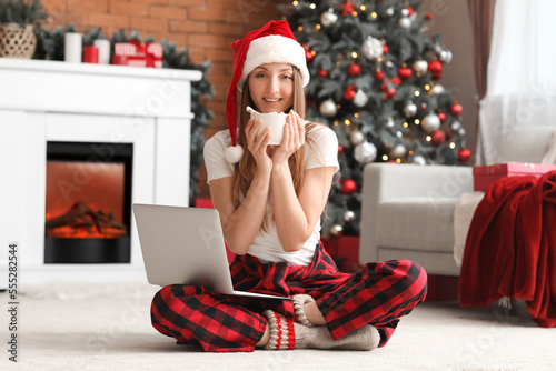 Young woman in pajamas with...