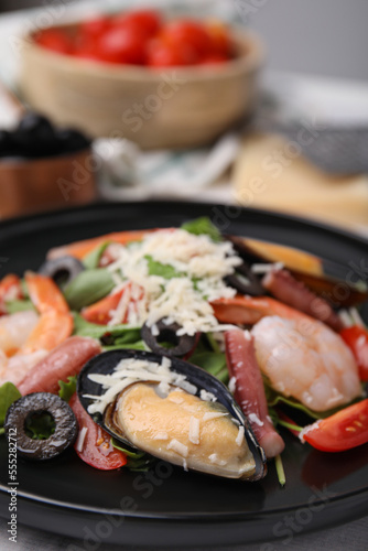 Plate of delicious salad with seafood, closeup view