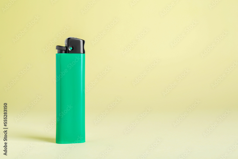 Stylish small pocket lighter on beige background, space for text
