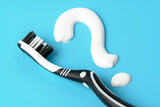 New toothbrush with toothpaste closeup on blue background closeup