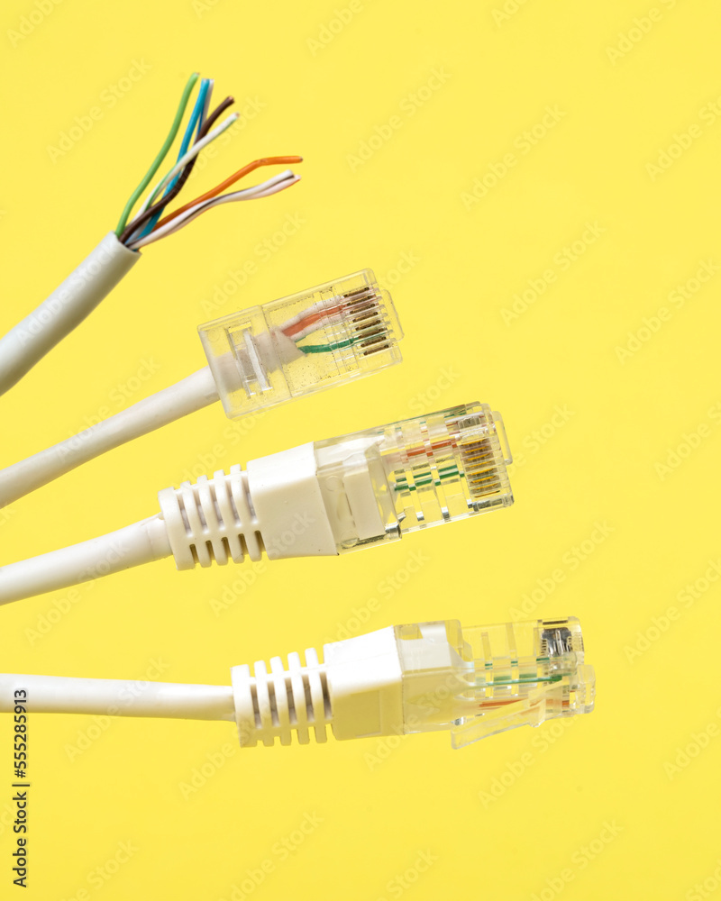 Network connection, internet connection and computer technology concept, close-up of ethernet cable connector, on yellow background Network connection, internet connection and computer technology concept, close-up of ethernet cable connector, on yellow background