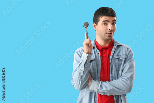 Young man with tablespoon o...