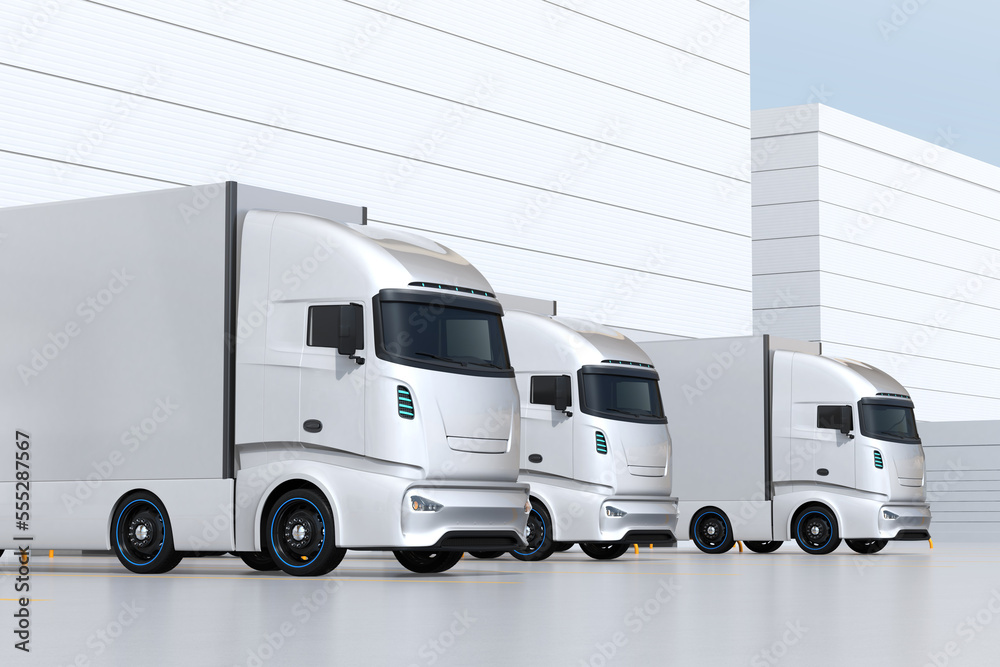 Fototapeta premium Generic design silver Electric Trucks parking at logistics center. 3D rendering image.